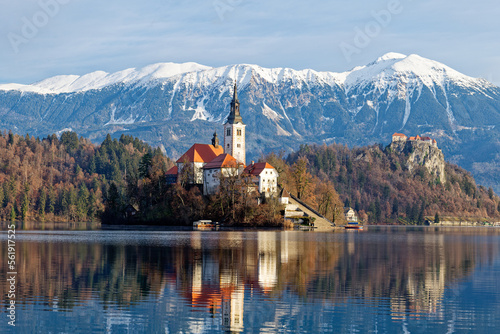 Sunrise winter scenery of magical Lake Bled in Slovenia. A winter tale for romantic experiences. Mountains with snow in the background. Church of the Mother of God on a little Island in the lake.