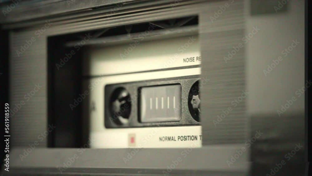 Retro music radio tape recorder, audio cassette playing close-up VHS. Listening to music, recording studio old radio boombox player, searching channel, volume. Retro music radio tape recorder, audio cassette playing close-up VHS. Listening to music, recording studio old radio boombox player, searching channel, volume.