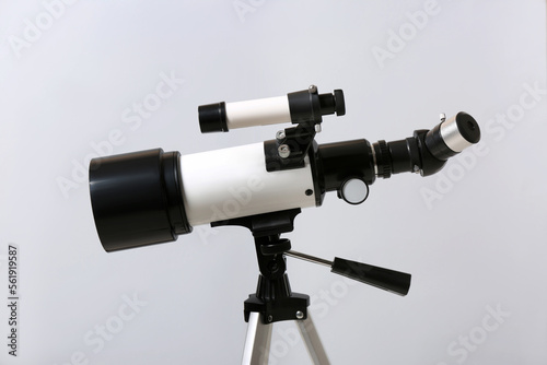 Tripod with modern telescope on light background, closeup