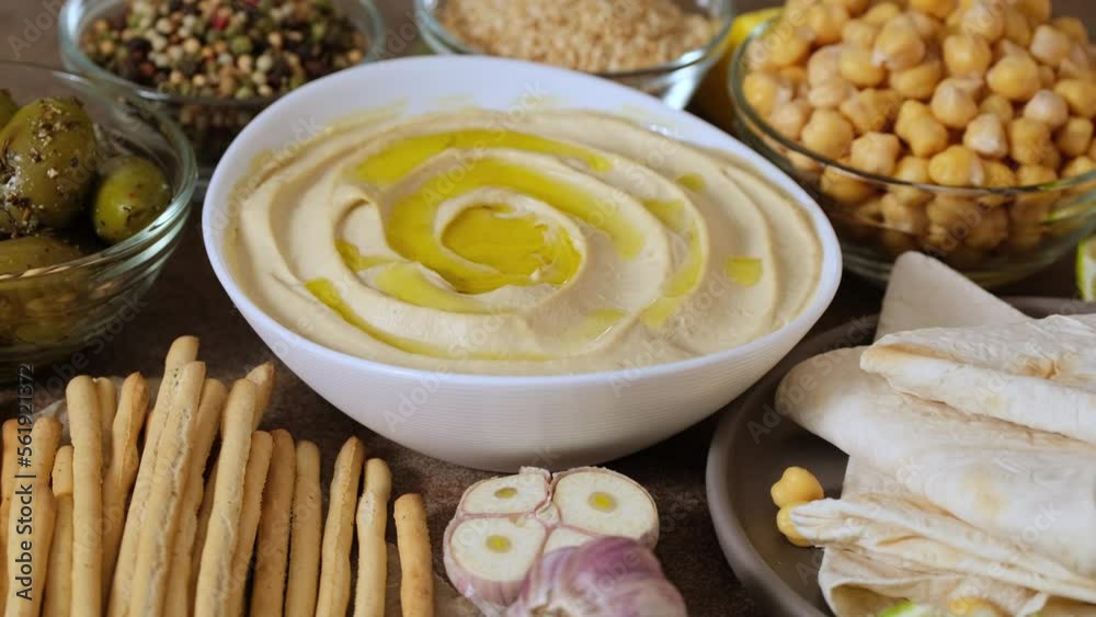 Chickpea hummus close up. Bowl of homemade natural organic hummus garnished with chickpeas, olive oil, spices. Hummus or fava, a hearty snack of legumes Chickpea hummus close up. Bowl of homemade natural organic hummus garnished with chickpeas, olive oil, spices. Hummus or fava, a hearty snack of legumes