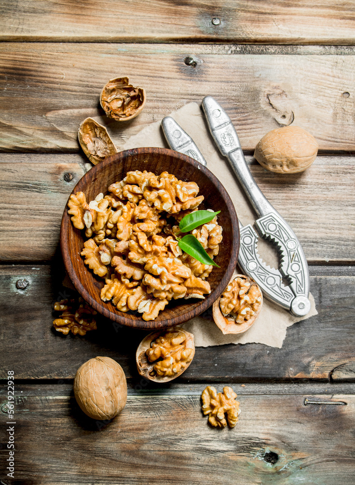 Fototapeta premium Shelled walnuts with a Nutcracker.