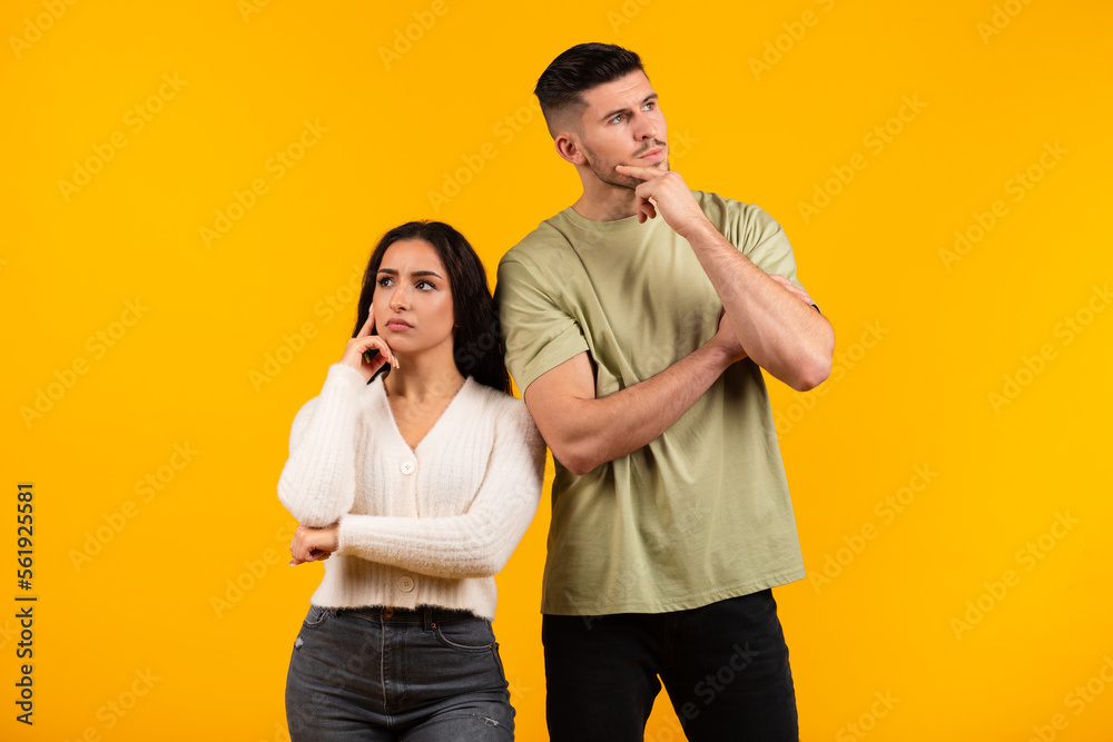 Pensive millennial middle eastern husband and wife thinking, look in different directions Pensive millennial middle eastern husband and wife thinking, look in different directions