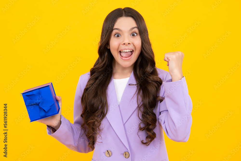 Amazed teenager. Portrait of teenager child girl 12, 13, 14, years old holding Christmas gift box. Teen giving birthday gift. Excited teen girl. Amazed teenager. Portrait of teenager child girl 12, 13, 14, years old holding Christmas gift box. Teen giving birthday gift. Excited teen girl.