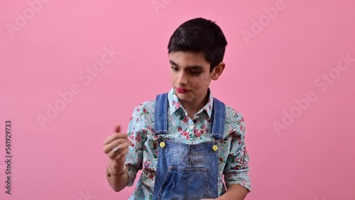 Young guy dancing and feeling girly. Gender confusion in adolescence. photo