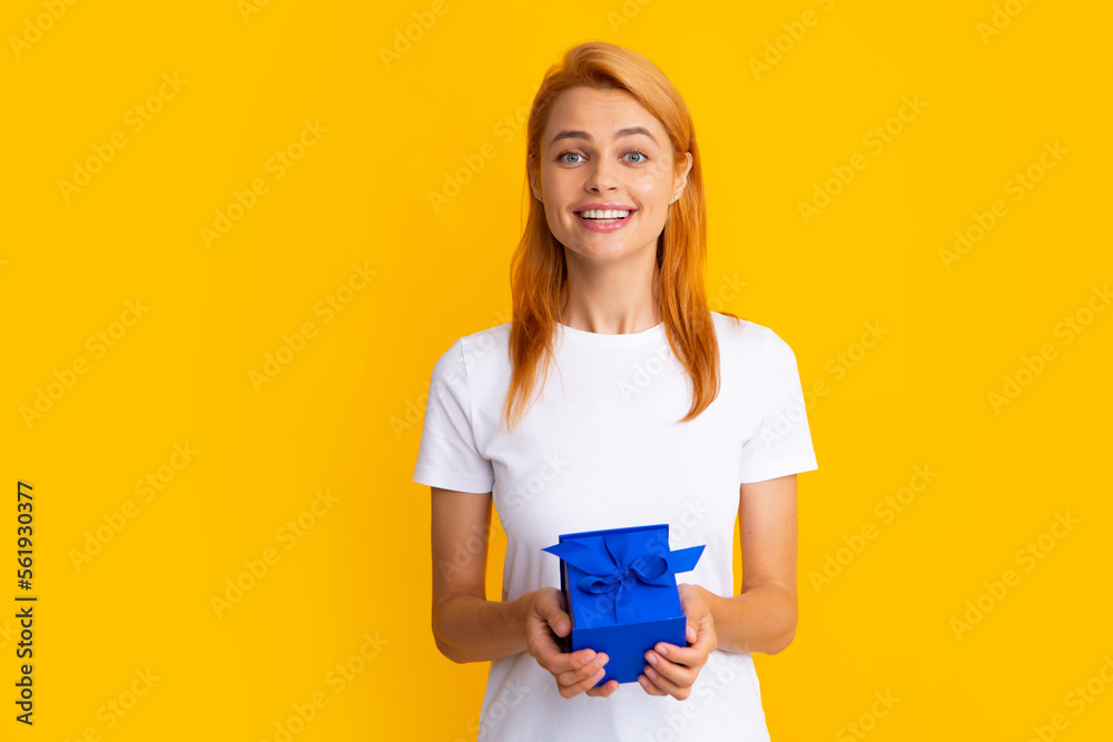 Attractive woman with present box posing with surprised face expression on gray background. Girl holding gift decorated with ribbon. Valentine day, birthday, happy new year gift people concept. Attractive woman with present box posing with surprised face expression on gray background. Girl holding gift decorated with ribbon. Valentine day, birthday, happy new year gift people concept.
