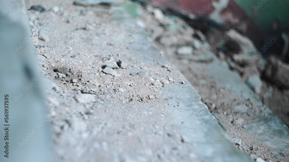 A guy runs down the stone steps. he's wearing sneakers on his feet. The stairs are very dirty. A guy runs down the stone steps. he's wearing sneakers on his feet. The stairs are very dirty.