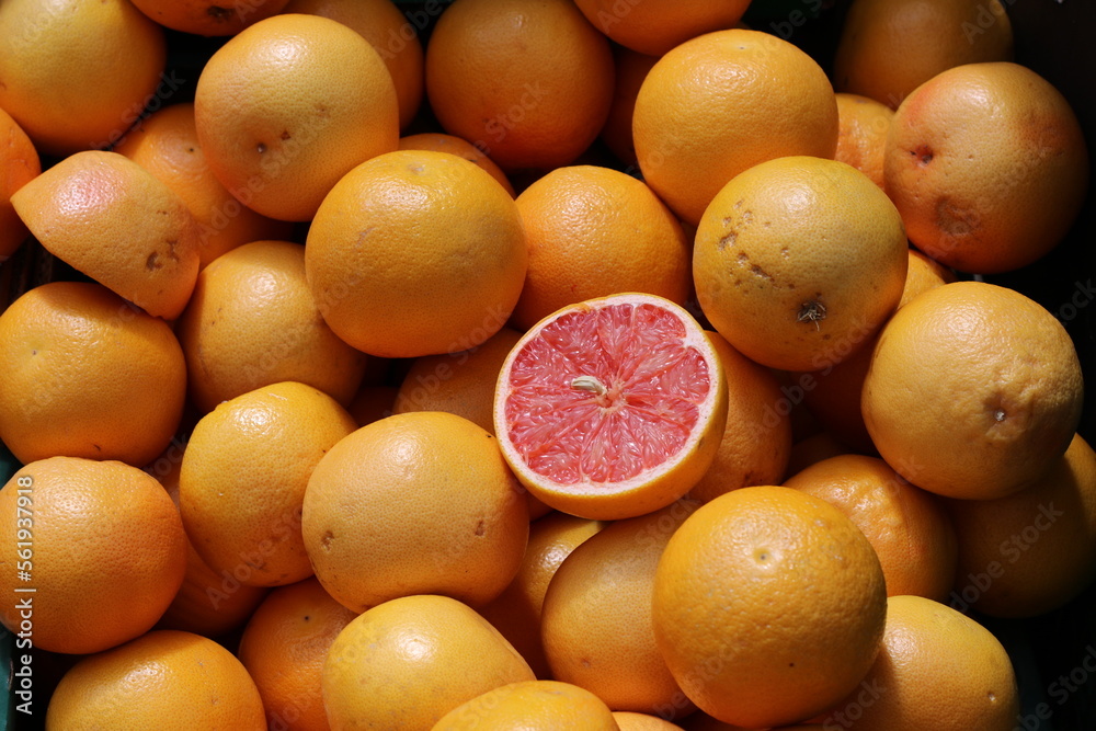 Sliced Red Blood Orange Citrus Standing Out Among Whole Oranges, Uniqueness concept Sliced Red Blood Orange Citrus Standing Out Among Whole Oranges, Uniqueness concept