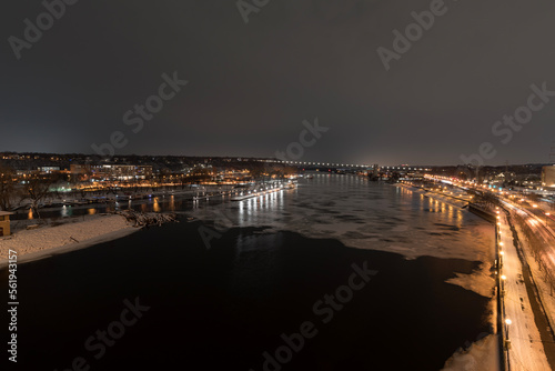 icy mississippi river and cityscape from robert street bridge in saint paul at night