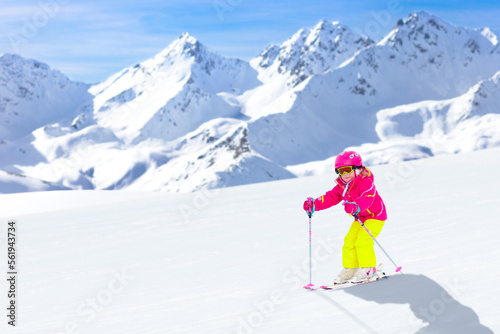 Ski and snow fun. Child in winter mountains.