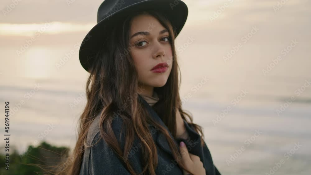 Charming woman standing coast overcast day close up. Portrait of calm brunette. Charming woman standing coast overcast day close up. Portrait of calm brunette.