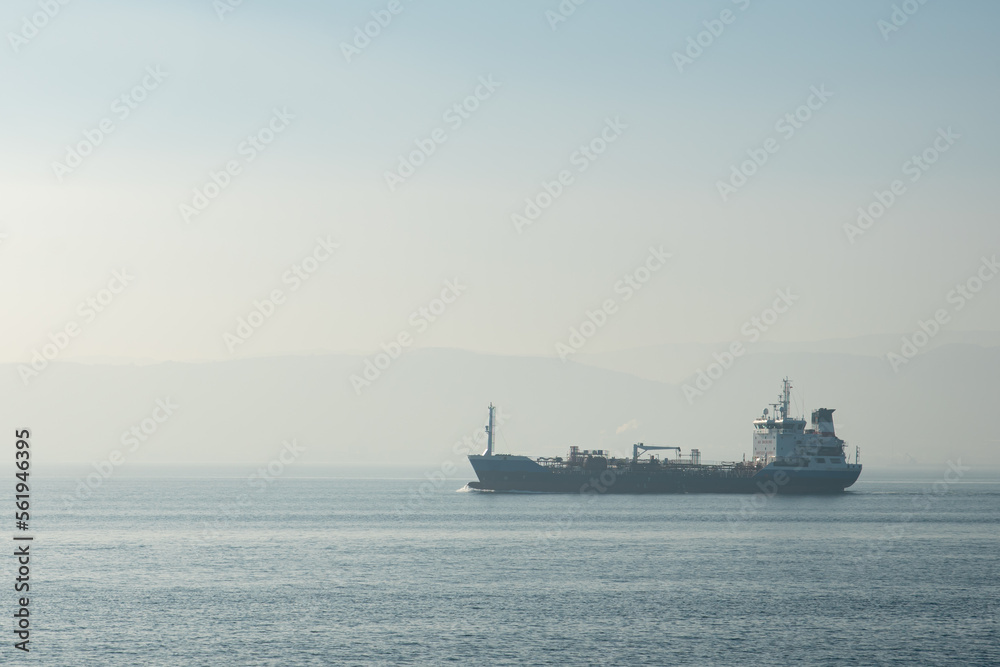 Cargo Ship at Sea , Aerial view of a solo cargo ship on the move in open waters during sunrise.