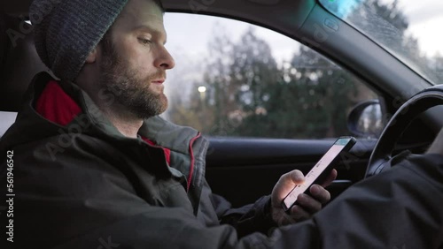 A middle aged caucasian man distracted driving while using a mobile device stops his vehicle suddenly to avoid an accident. 4K 24FPS