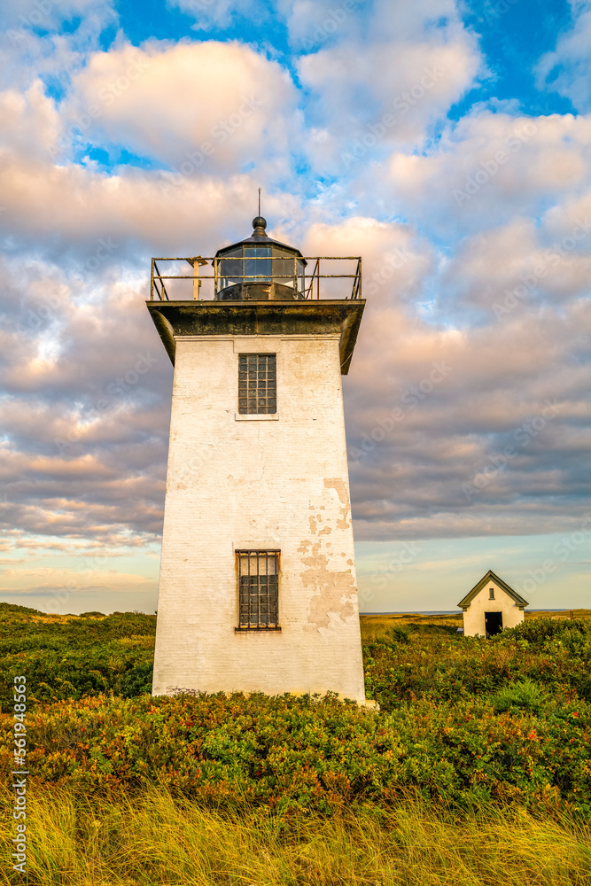 Wood End Lighthouse in Provincetown on Cape Cod, Massachusetts, USA, oceanside beach seascape at golden sunset