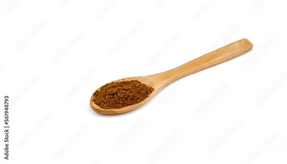 Pile of Garam Masala in a wooden spoon isolated on white background. Indian spice mix Pile of Garam Masala in a wooden spoon isolated on white background. Indian spice mix