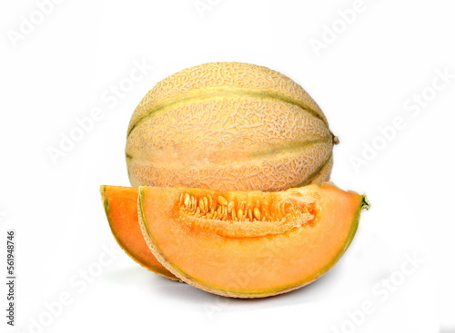 Ripe delicious melon and a piece of melon are isolated on a white background.