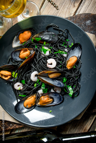 Mediterranean food. Spaghetti with cuttlefish ink, clams and white wine.