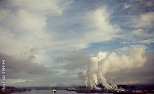 Smoke, steam, and pollution rises from an industrial plant. photo