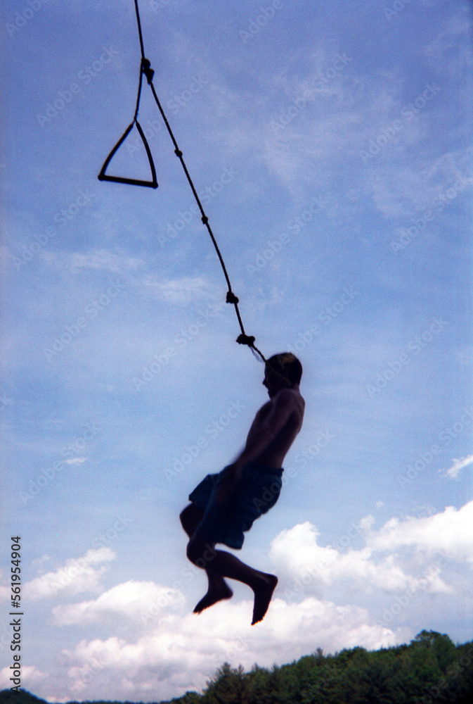 A boy drops from a rope swing into a lake in North Carolina. A boy drops from a rope swing into a lake in North Carolina.