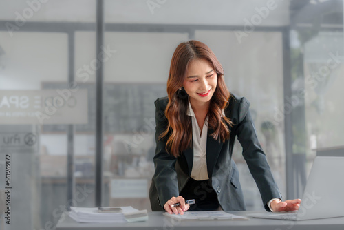 Confident asian business professional finance trader woman using trading app on laptop, sitting at monitor with trading infographics, charts, rates, chatting online, getting income, profit, smiling Free Download Confident asian business professional finance trader woman using trading app on laptop, sitting at monitor with trading infographics, charts, rates, chatting online, getting income, profit, smiling - GFXLoad