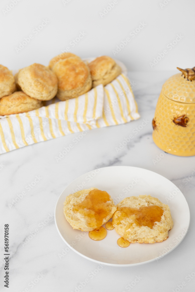 Close-up of Freshly Baked Homemade Buttermilk Biscuits with Honey Close-up of Freshly Baked Homemade Buttermilk Biscuits with Honey