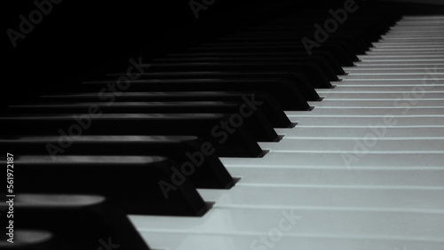 High-resolution  professional-grade photo of a piano keyboard with well-lit  glossy black and white keys. Perfect for illustrating music  performance  and creativity. 