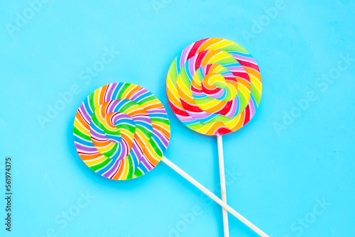 Rainbow lollipop on blue background.