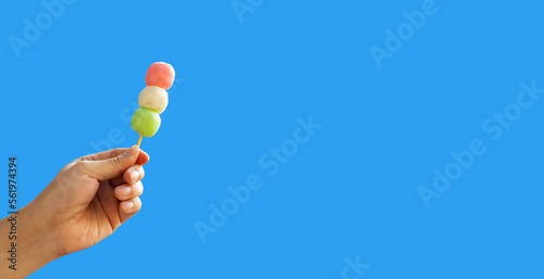 Japanese dessert, Dango on stick in hand on blue sky