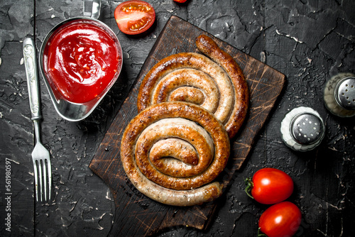 Grill sausages with tomato sauce and spices.