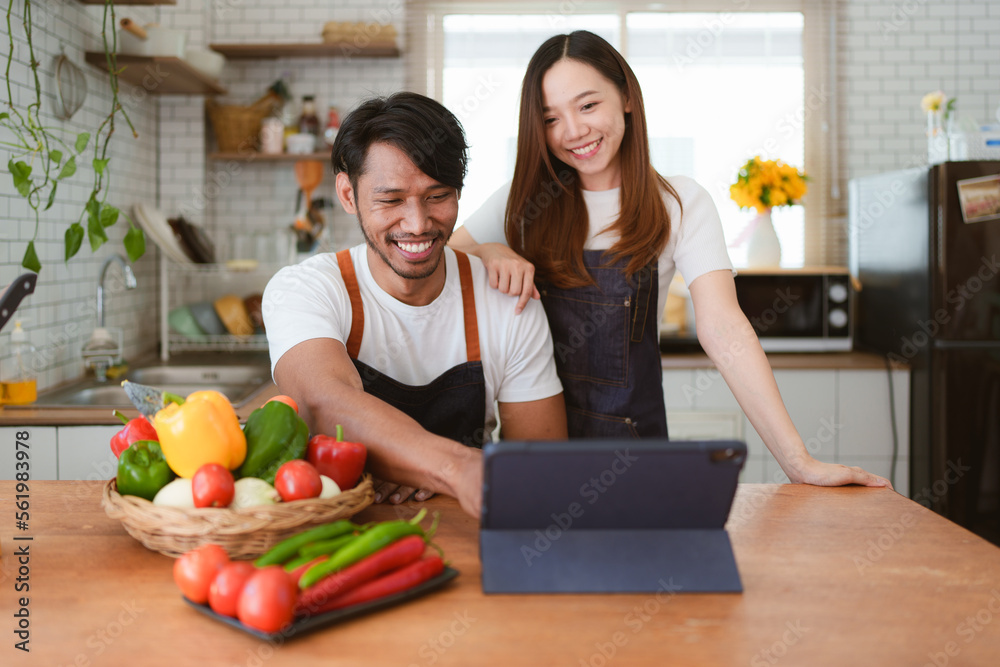 Portrait of young asian couple making salad together at home. cooking food and Lifestyle moment and healthy Portrait of young asian couple making salad together at home. cooking food and Lifestyle moment and healthy