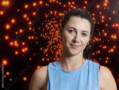 Portrait of a beautiful young woman with a blue short sleeve shirt and a sparkly background