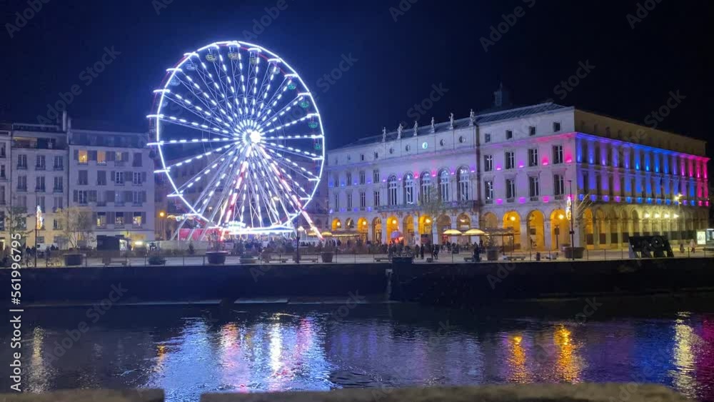 an impressive view of the Ferris wheel in the beautiful city of Bayona, illuminated by Christmas lights. the festive atmosphere of the Christmas fair can be appreciated in all its glory an impressive view of the Ferris wheel in the beautiful city of Bayona, illuminated by Christmas lights. the festive atmosphere of the Christmas fair can be appreciated in all its glory