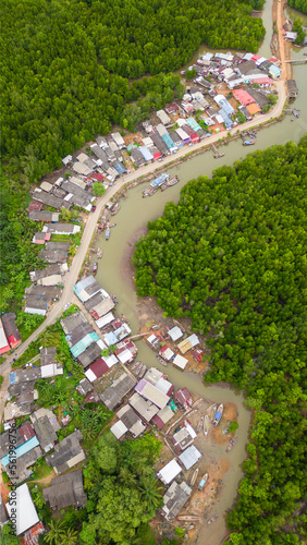 Aerial photography of the beautiful fishing village with its colorful houses surrounded by forests in Phang nga bay. Thailand