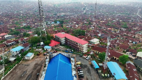 Aerial - Forward tilt-down shot of Mapo hall and Ibadan metropolis