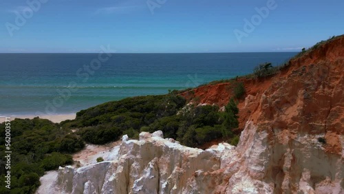 Scenic red rock Pinnacles at Beowa and Ben Boyd National Park, New South Wales, Australia, near Sydney. Drone aerial view of seaside sandy beach sea in 4K UHD. Tourist attraction nature documentary. photo