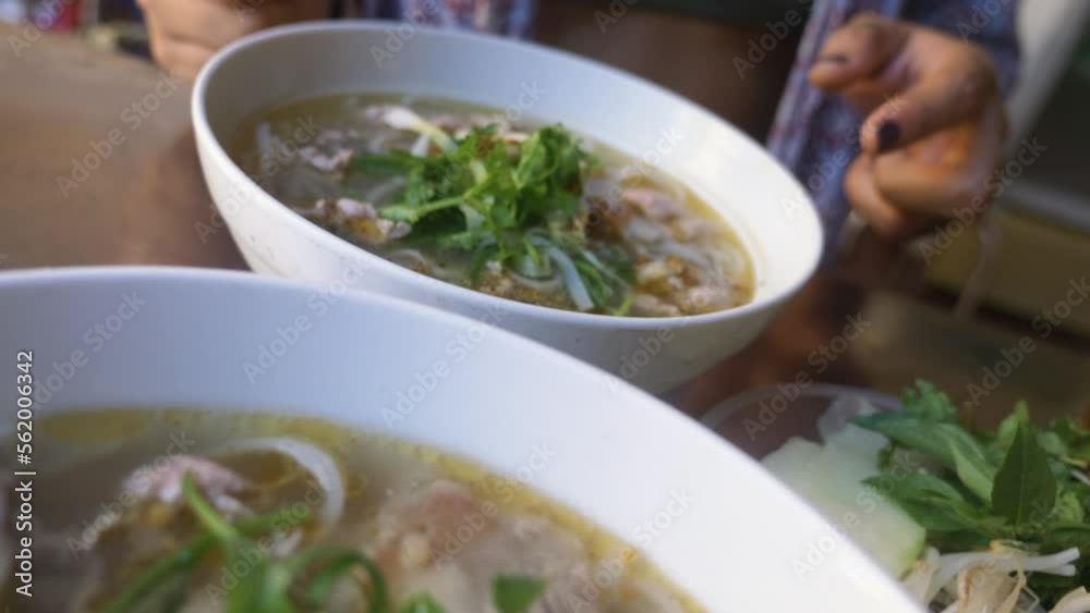 Sexy girl in bikini eating traditional pho beef noodle soup in local vietnamese restaurant. Sexy girl in bikini eating traditional pho beef noodle soup in local vietnamese restaurant.