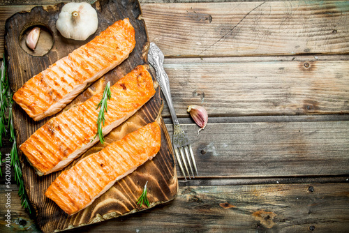 Grilled salmon fillet with garlic and rosemary.