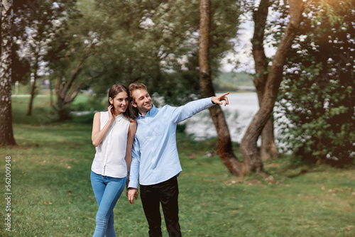 image of a young couple on a walk along the lake shore.