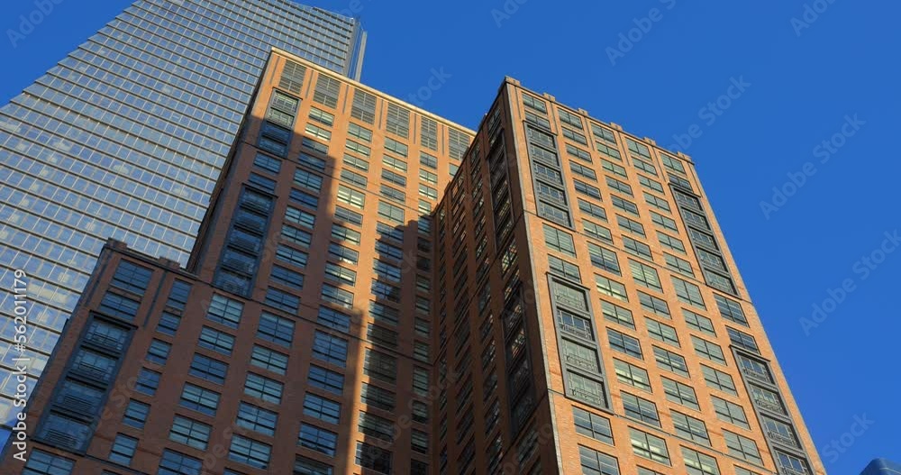 Looking Up On High-Rise Buildings During Sunny Day In Manhattan, New York, USA. Low Angle Looking Up On High-Rise Buildings During Sunny Day In Manhattan, New York, USA. Low Angle