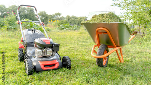 Lawn mover on green grass in modern garden. Machine for cutting lawns.