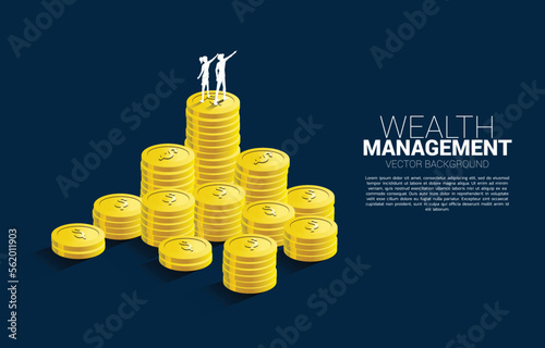 Silhouette of businessman and businesswoman standing point finger on top of stack of coin. Concept of success investment and growth in business