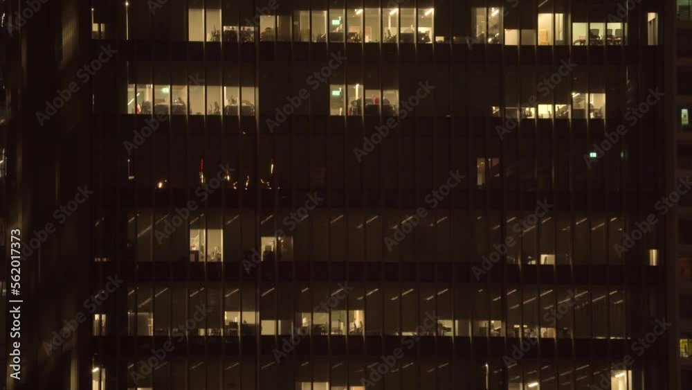 Illuminated Urban Building Window from the Office at Night Illuminated Urban Building Window from the Office at Night