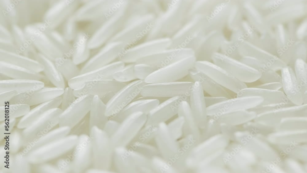 Close up of uncooked white rice falling. Close up of uncooked white rice falling.