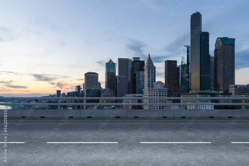 Empty urban asphalt road exterior with city buildings background. New modern highway concrete construction. Concept way to success. Transportation logistic industry fast delivery. Seattle. USA. Empty urban asphalt road exterior with city buildings background. New modern highway concrete construction. Concept way to success. Transportation logistic industry fast delivery. Seattle. USA.