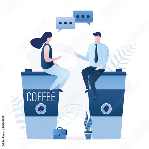Office workers sit on large mugs of coffee and talk. Coffee break, colleagues are discussing work. Pause in work process, rest, recharge. Office workflow, coffee break.