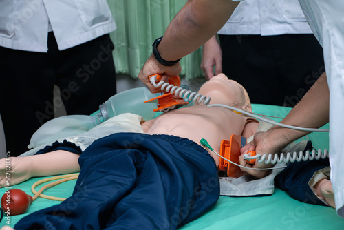 doctor defibrillate dummy emergency resuscitation. CPR Training in emergency refresher training to assist of physician. concept of saving lives.