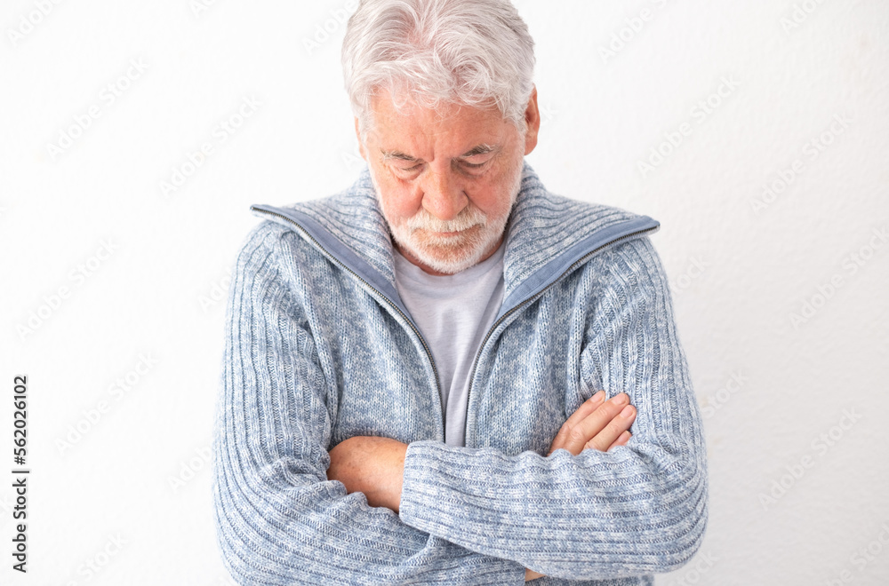 Sad unhappy old man with crossed arms looking down, senior male suffering for divorce, bad relationship, feeling lonely and depressed Sad unhappy old man with crossed arms looking down, senior male suffering for divorce, bad relationship, feeling lonely and depressed