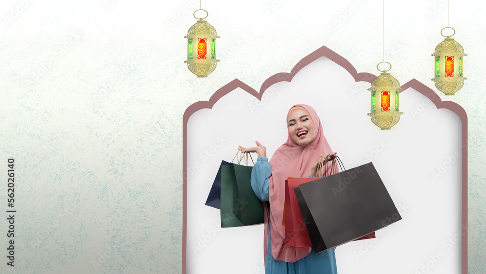 Asian Muslim woman in veil holding shopping bags Asian Muslim woman in veil holding shopping bags
