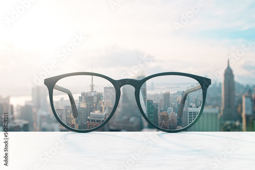 Look through eyeglasses at blurred city with mock up place on sky backdrop. Vision and perspective concept. 3D Rendering.