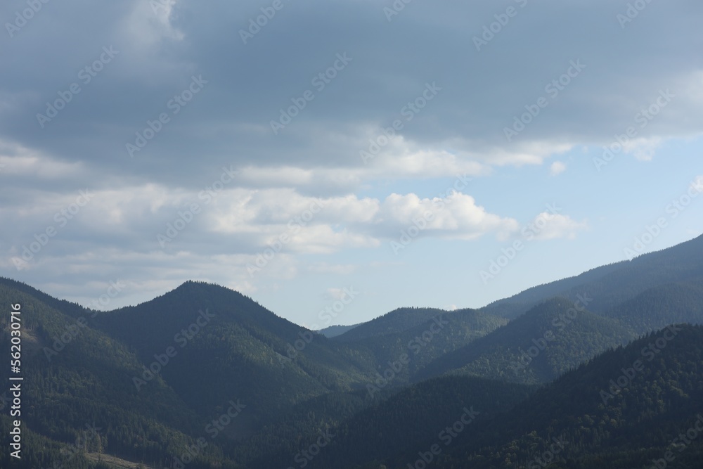 Beautiful view of majestic mountains under cloudy sky