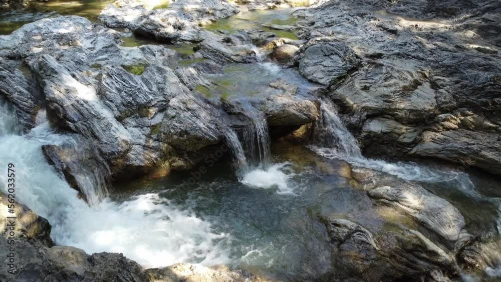 Waterfall close-up, smooth movement. Mountain river, clear water. Wildlife. 4k
